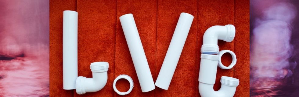 White plumbing pipes arranged to spell "LVE" on a textured orange background, symbolizing plumbing maintenance in romantic living situations.