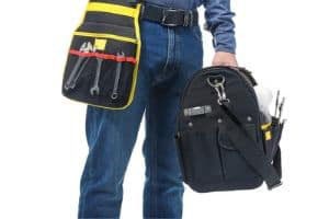 Person wearing a tool belt and carrying a plumbing tool bag, representing professional plumbing services and eco-friendly solutions.