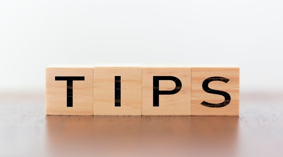 Wooden blocks spelling "TIPS," symbolizing advice and guidance related to plumbing solutions and eco-friendly practices.