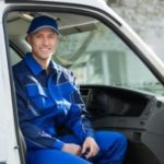 Male service worker in a blue uniform inside a white van, representing Lodder Brothers Limited's gas leak detection services.