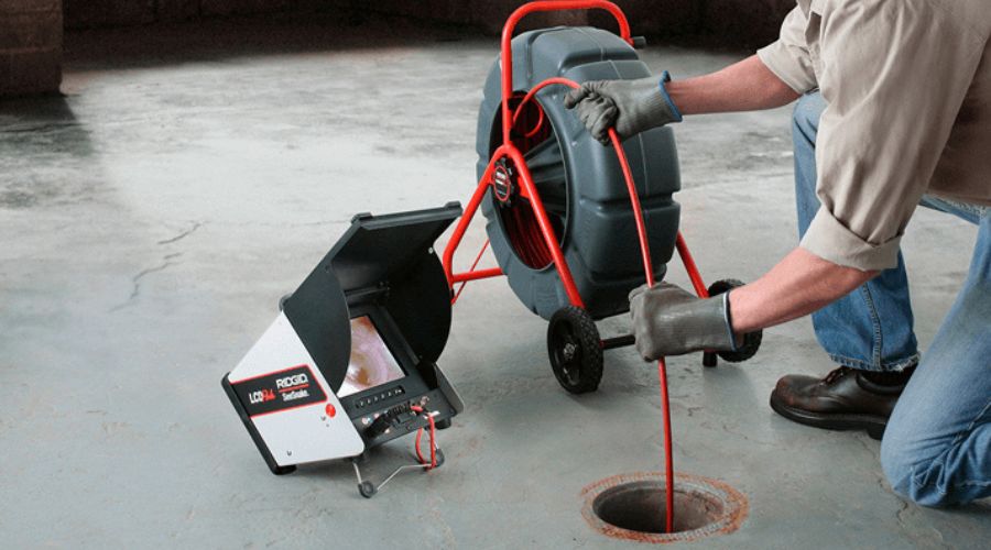 Technician using an inspection camera and drain equipment for plumbing maintenance at Lodder Brothers Limited.