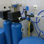 Two blue cylinders with connected piping and valves, part of water filtration systems by Lodder Brothers Limited.