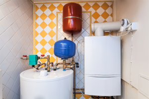 Water heater and expansion tanks in a residential plumbing setting, highlighting water heater maintenance and repair services.