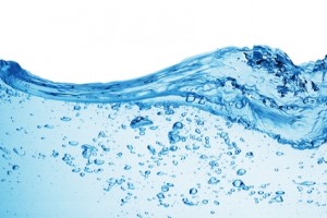 Water wave with bubbles illustrating the importance of water quality and the function of water softeners in removing hard minerals.